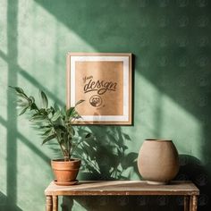 a green wall with a wooden table and potted plant