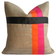 an orange and pink striped pillow on a white background