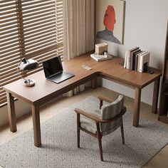 a computer desk with a laptop on top of it next to a chair and bookshelf