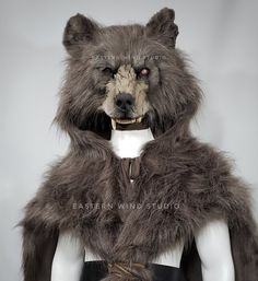 an animal that is wearing a fur coat on top of a mannequin's head