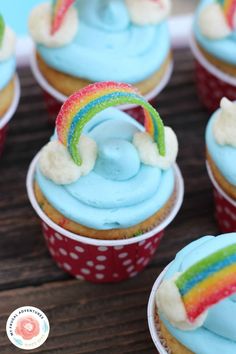 cupcakes with blue frosting and rainbow decorations