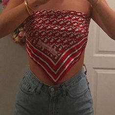 a woman is taking a selfie in the mirror with her cell phone while wearing a red and white crop top