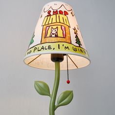 a lamp that is on top of a table with a plant in front of it