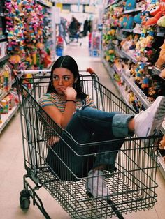 a woman is sitting in a shopping cart