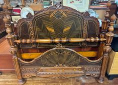 an antique wooden bed frame with intricate carvings