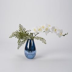 a blue vase with white flowers in it