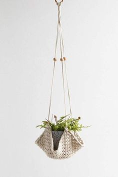 a hanging planter with plants in it