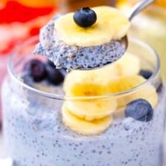 blueberry and banana smoothie in a glass with a spoon sticking out of it