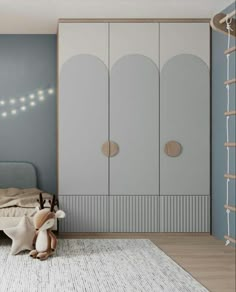 a child's bedroom with blue walls and white furniture