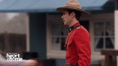 a man in a red uniform is walking