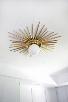 a ceiling light that is in the middle of a room with white walls and ceilings