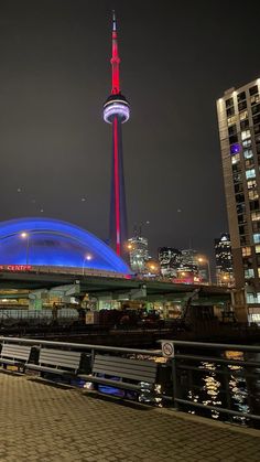 the sky tower is lit up in red, white and blue