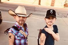 two young men wearing cowboy hats standing next to each other