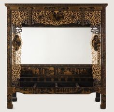 an ornately decorated wooden cabinet with mirror on the front and side panels inlays