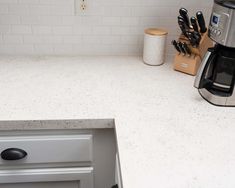 a kitchen counter top with knives on it