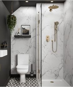 a white toilet sitting in a bathroom next to a walk in shower with a black and white tiled floor