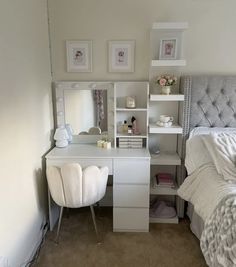 a bedroom with a bed, desk and mirror