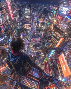 a man standing on top of a tall building in the middle of a city at night