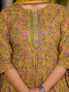 This 3-piece set includes mustard thread work, floral print anarkali kurta has round-neck, 3/4th sleeves, flared hem, calf length teamed with printed trouser pants with slip on elasticated waistband & slip on closure and a voile dupatta. Washing instructions state to hand wash. The model wearing the size small is 5'8 in height. 3 Piece Set Color-Mustard Suit Fabric- Cotton Dupatta Fabric-Cotton Work - Floral Print detailing Neck - Round Neck Sleeves - 3/4th sleeves Length-Calf Length Bottom - Printed Trouser Bottom - Elasticated Waistband & Slip-on Closure Washing Care-Hand Wash The model height 5'8 is wearing a size small Floral Print Anarkali, Printed Anarkali Suits, Stylish Kurtis Design, Cotton Anarkali, Kurta Design, Anarkali Kurta, Dress Design Patterns, Cotton Dupatta, Kurti Designs Party Wear