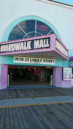 the entrance to boardwalk mall is pink and blue with white lettering on it's marquee