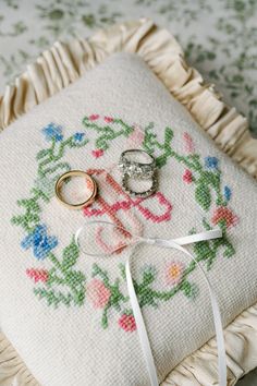 two wedding rings are sitting on top of a pillow