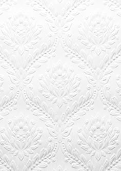 an up close view of the white fabric with intricate designs on it's surface