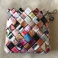 a small purse made out of lipsticks on the floor with a keychain attached to it