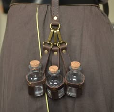 a belt with four bottles attached to it's back and two straps on the waist