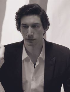 a man in a black suit and white shirt