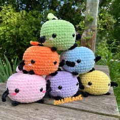 small crocheted stuffed animals sitting on top of a wooden table