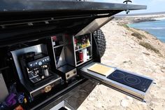 the back end of a truck with an oven and stove in it's bed