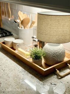 a table lamp sitting on top of a wooden tray