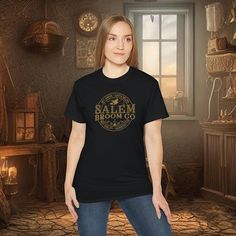 a woman standing in front of a window wearing a t - shirt that says salem brook co