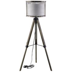 a tripod floor lamp with a silver shade