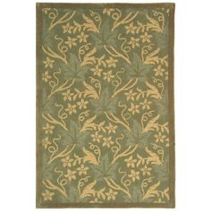 a green and gold rug with an intricate design on the bottom, in front of a white background