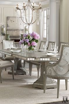 a dining room table with chairs and a chandelier