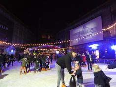 people skating on an ice rink at night