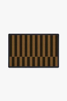 a brown and black door mat on a white wall