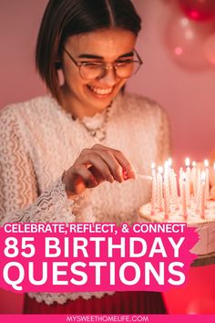 a woman holding a birthday cake with candles on it and the words celebrate reflect & connect 85 birthday questions