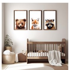 three pictures of different animals hanging on the wall in a baby's room with a crib