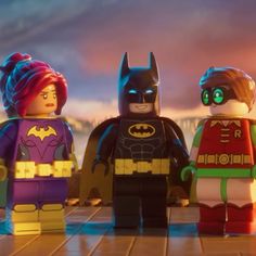 the lego batman movie characters are standing in front of a cityscape at night