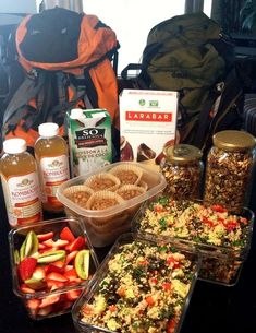 several containers filled with food sitting on top of a table next to other foods and condiments