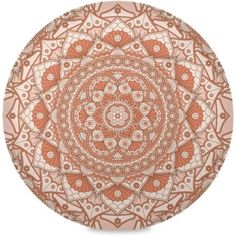 an orange and white plate with intricate designs on the front, in shades of brown