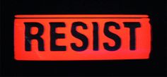 a red and black sign that says resist