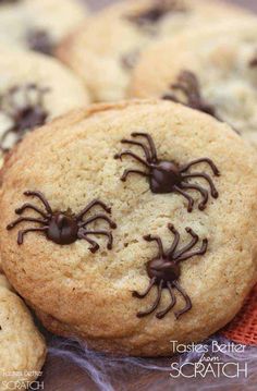 cookies decorated with chocolate spider webs and sprinkles are on a table