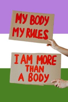 two people holding signs that say, my body rules i am more than a body