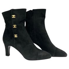 - Chanel black suede ankle boots. A classic collectable item! - Gold Hardware CC turn-lock style. - Side zip closure. - Size 37. Luxury Winter Ankle Boots, Chic Luxury Boots With Zipper Closure, Luxury Designer Boots With Block Heel, Luxury Boots With Buttons And Round Toe, Luxury Black Lace-up Cap Toe Boots, Luxury Designer Ankle Heeled Boots, Chic Luxury Boots, Luxury Black Boots For Work, Luxury Black Heeled Boots