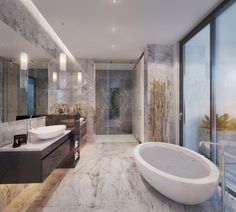 a bathroom with marble walls and flooring, large bathtub next to the sink