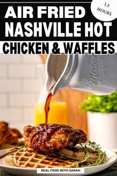 chicken and waffles are being poured on top of the fried nashville style hot sauce