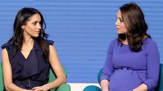 two women sitting in chairs talking to each other